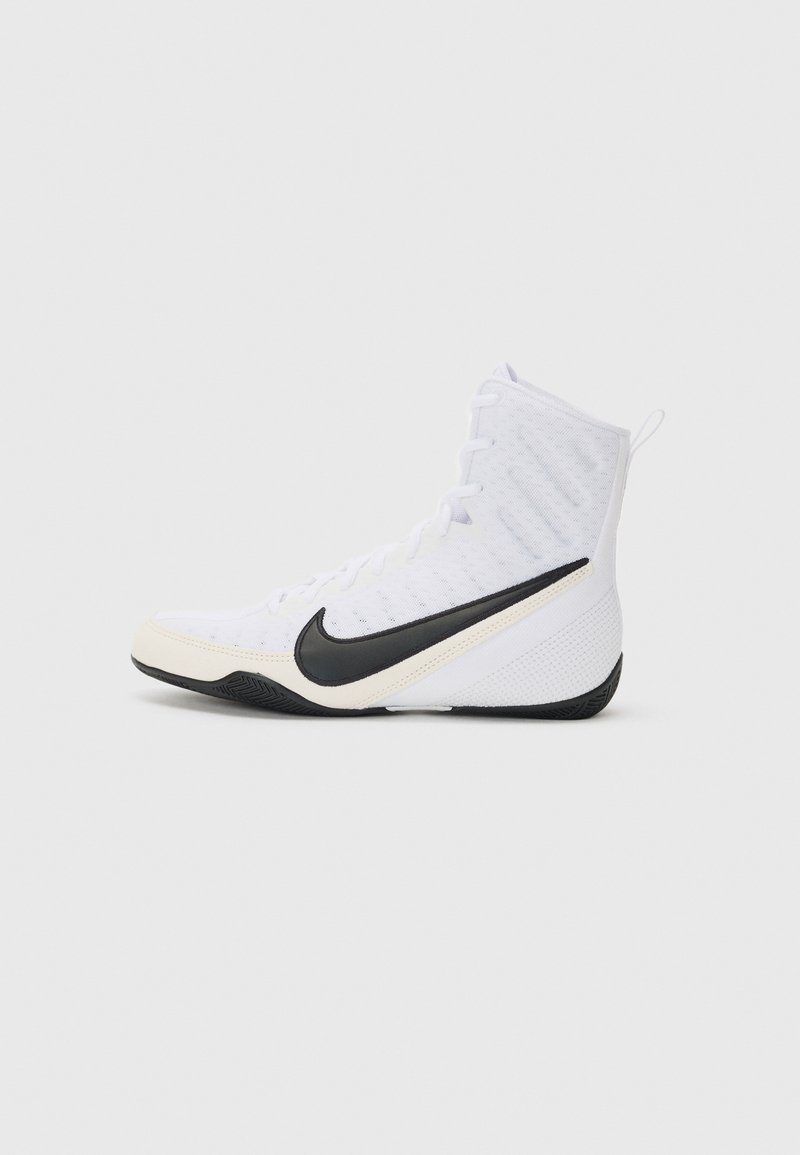 Nike athletic shoe in white with a black swoosh. Features a high-top design, textured upper, and a durable rubber outsole.
