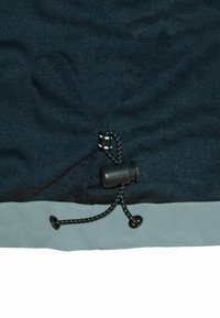 Black fabric with a textured surface, featuring an elastic drawstring toggle and a gray waterproof hem with a smooth finish.
