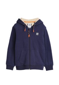 Marine blauwe rits-hoodie met een zachte beige fleece-voering in de capuchon, oranje koordaccenten en twee voorzakken. Inclusief een logo-patch op de borst.