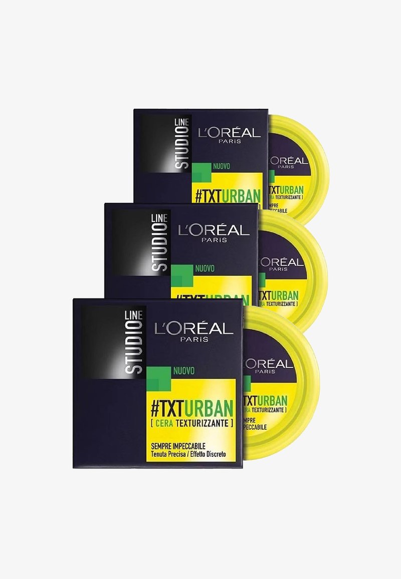 Ceretta texturizzante L'Oréal Paris Studio #TXTURBAN confezionata in una scatola scura con accenti gialli vivaci, con vasetti rotondi e etichette di testo audaci.
