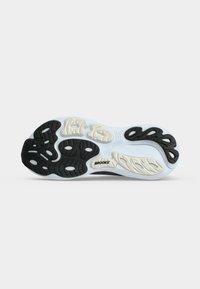 Sole of a running shoe showing black and white tread patterns and the Brooks brand name on a light background.