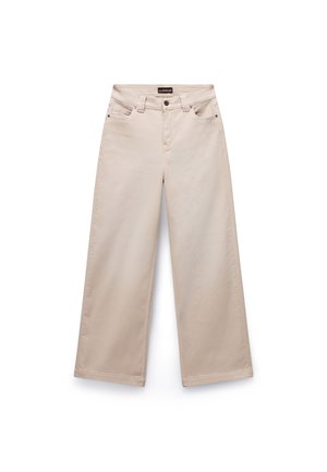 Beige wide-leg trousers made of cotton with a smooth texture. Features five pockets, belt loops, and silver-tone hardware on the front.