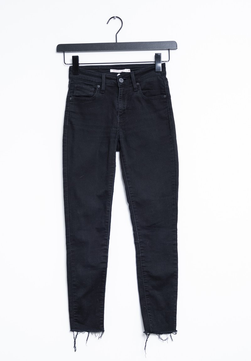 Svarta denim skinny jeans med medelhög midja, fem-ficksdesign och fransade fållar. Materialet är mjukt med en lätt stretch.