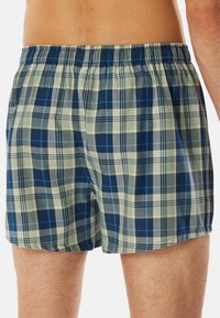 Blauwe en beige geruite boxershorts met een elastische tailleband, voorzien van een zachte textuur en een losse pasvorm.