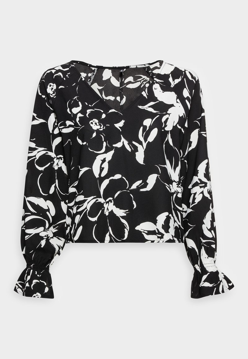 Blouse noire à motif floral avec des fleurs blanches, col en V, manches longues avec poignets froncés, longueur courte, et texture de tissu lisse.