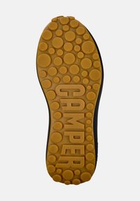 Rubber sole with circular patterns, featuring "GAMPER" embossed in large letters. Black edge detail and size "42" marked on surface.