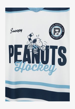Bijeli hokejaški dres s natpisom "PEANUTS Hockey" velikim crnim slovima, plavim naglascima i slikom Snoopyja u hokejaškoj opremi. Okrugla značka na prsima.