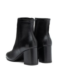 Botas de cuero negro hasta el tobillo con un acabado suave, tacón cuadrado y cremallera lateral para ponerlas y quitarlas fácilmente. Diseño de punta redondeada y altura hasta el tobillo.