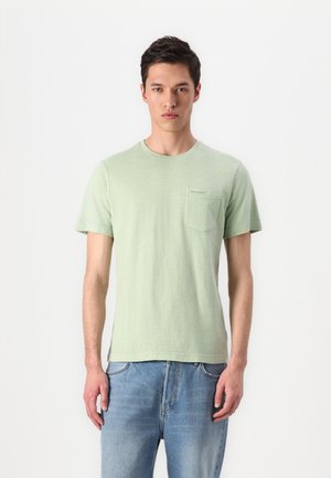 Light green short-sleeve t-shirt with a round neck, featuring a small chest pocket. The fabric has a soft texture with a subtle pattern.
