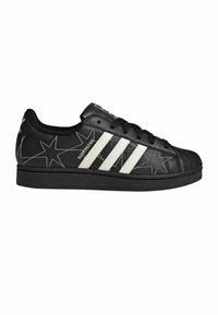 Black sneakers with white three-stripe design, star pattern, and rubber toe cap. Made of synthetic leather with rounded shape and flat sole.