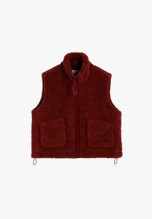 Red fleece vest with a high collar, full front zipper, and two large patch pockets. Textured material with a soft, warm appearance.