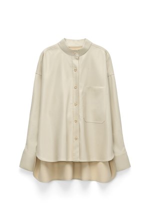 Beige button-up shirt with a mandarin collar, a single chest pocket, and long sleeves with wide cuffs; smooth texture, slightly loose fit.
