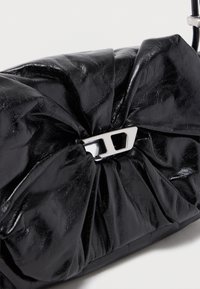 Shiny black ruched leather clutch purse with silver geometric clasp on a white background.