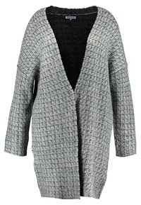 Lång, översized cardigan i texturerad grå och svart stickning. Har en djup V-ringning och vida ärmar. Öppen frontdesign utan knäppningar.