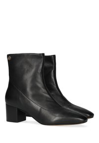 Botas de cuero negro hasta el tobillo con punta afilada, tacón cuadrado y diseño sin costuras; cuentan con un pequeño acento de logo en el lateral.