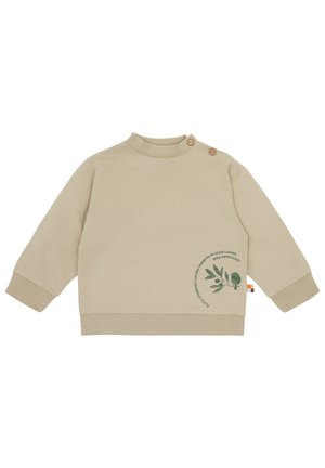 Top beige a maniche lunghe con colletto alto, dotato di due bottoni in legno. Una grafica di una foglia verde e un uccello è stampata sul davanti. Texture morbida.