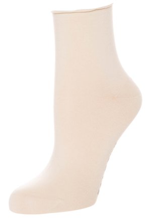 Chaussette beige jusqu'à la cheville en tissu lisse et extensible. Elle présente un poignet côtelé avec un orteil sans couture et un talon ajusté pour un confort et un soutien optimaux.