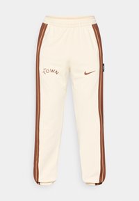 Grietos kelnės su rudos spalvos šoninėmis juostelėmis, su logotipu "The Town" ir Nike swoosh. Elastingas juosmuo ir gipiūras ant rankovių. Minkšta, lygi medžiaga.