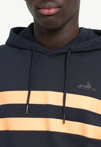 Navy hoodie with three horizontal orange stripes, drawstring hood, and black accents. Features a subtle mountain logo on the chest.
