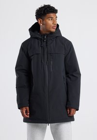 Black waterproof parka jacket with a drawstring hood, front zip closure, two side pockets, and a smooth texture.