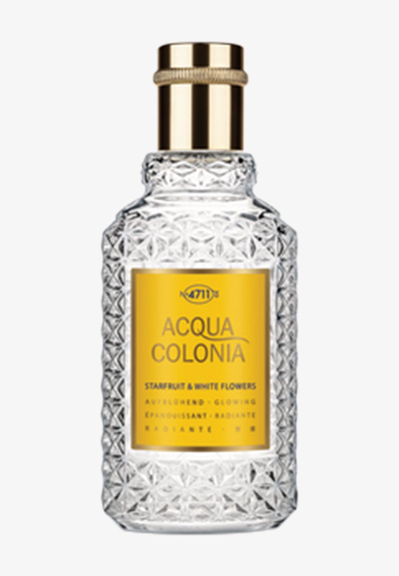 Flacon de parfum en verre clair et décoré, avec un bouchon doré et une étiquette jaune portant l'inscription « Acqua Colonia Starfruit & White Flowers ».