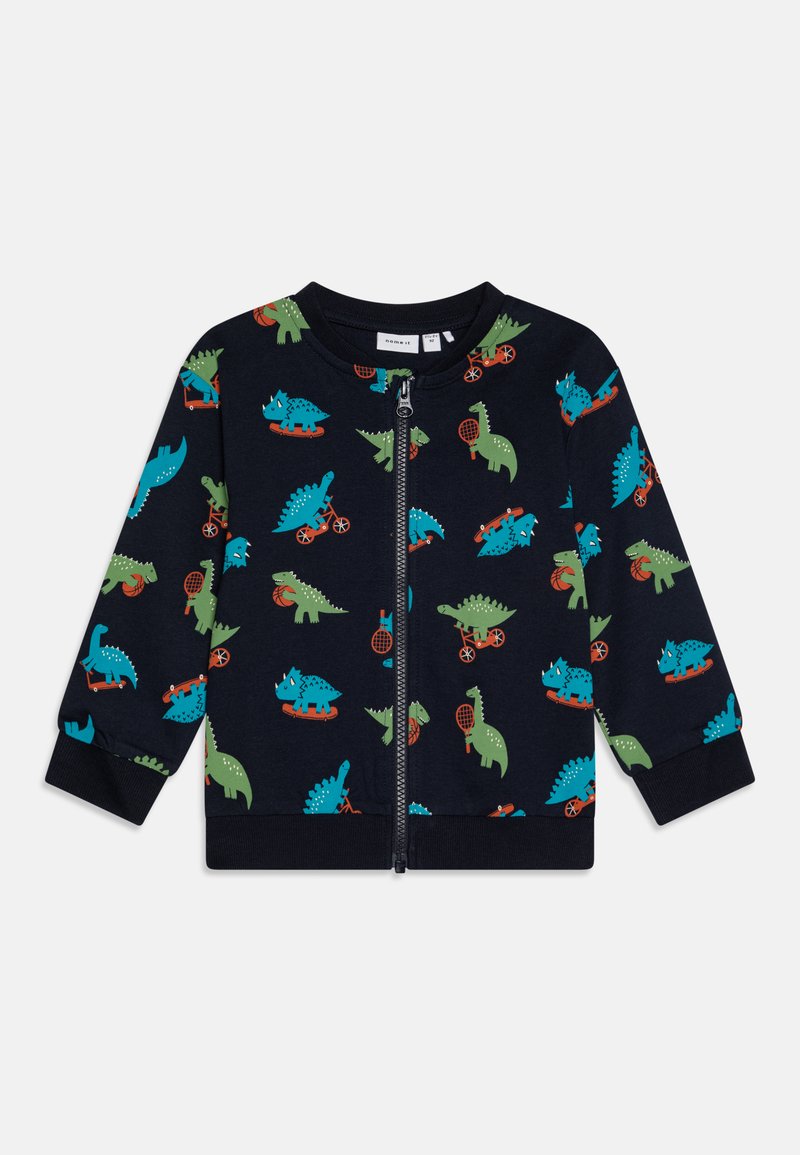 Jūros kariuomenės zip-up tipo striukė su spalvingais dinozaurų raštais žalia ir mėlyna, su raudonais akcentais. Minkšta medžiaga, guminiai rankogaliai ir apačia.