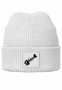 White knit beanie with ribbed texture. Features a rectangular patch displaying a black fish skeleton design with a heart.