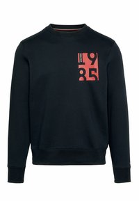 Sudadera negra de cuello redondo con números rojos en bloque "1985" y el texto pequeño "Hilfiger" en la parte superior izquierda del pecho.