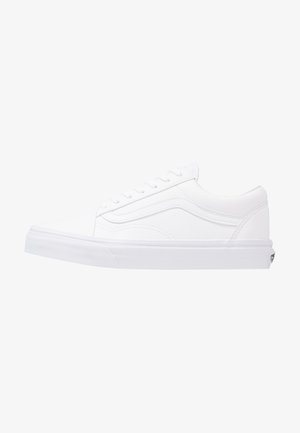 White canvas sneakers with a flat rubber sole, round toe, and classic lace-up design. Features side stitching and minimal branding.