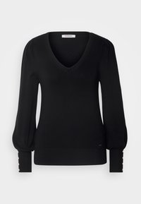 Maglione nero a maniche lunghe con scollo a V profondo, spalle arricciate e polsini a coste decorati con bottoni metallici. Materiale in morbido maglione.