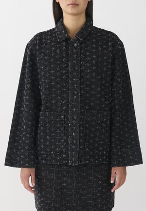 Black denim jacket with a subtle repeated pattern, featuring a collared neckline, button closure, and two front pockets.