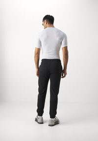 Champion ICONS CUFF PANTS LARGE LOGO - Pantalones deportivos - black