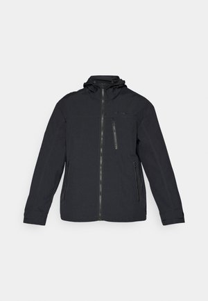 Black hooded jacket made from durable fabric. Features a front zipper, side pockets, and a zippered chest pocket. Simple design with minimal accents.