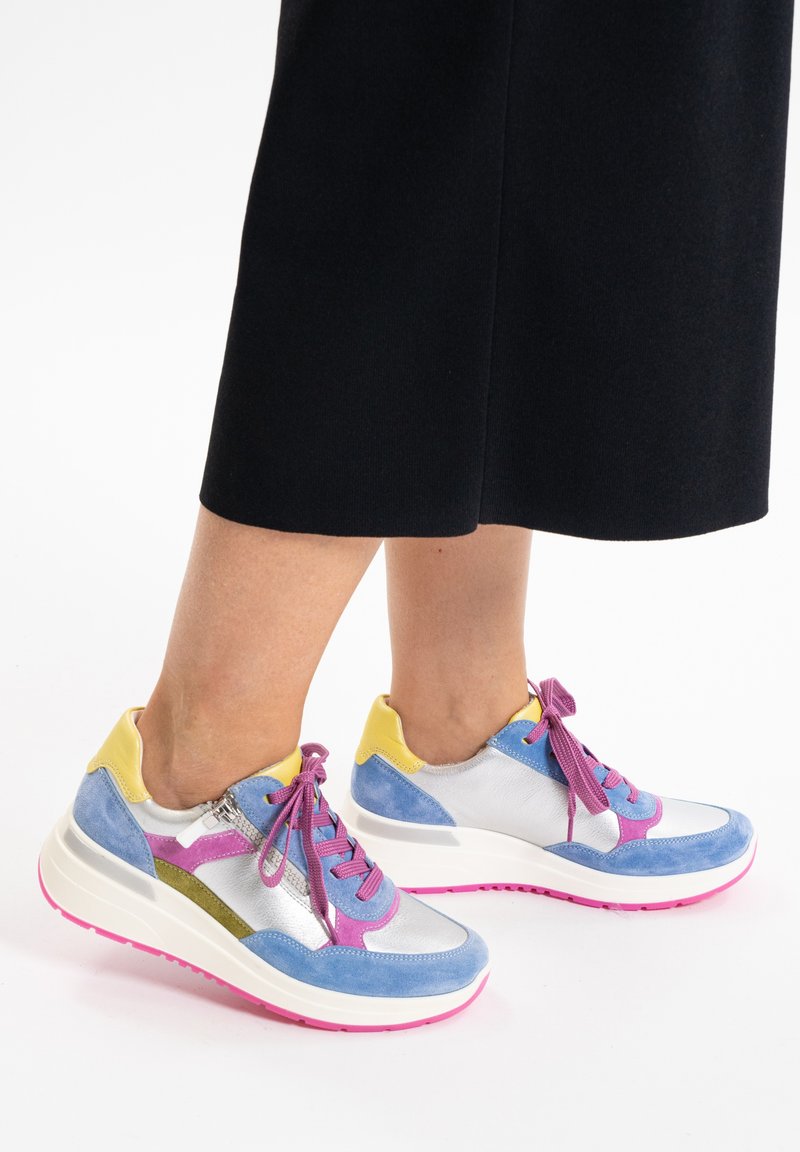 Colorful athletic shoes featuring blue suede, silver textile, and yellow accents. Thick white sole with pink detailing and purple laces.