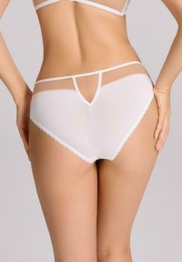 Białe majtki z przezroczystymi panelami z siateczki, w designie T-back oraz koronkowym wykończeniem na krawędziach, prezentujące gładkie wykończenie i nowoczesny krój.