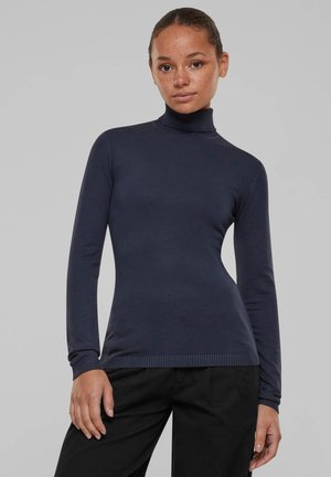 Navy turtleneck long-sleeve top made of a smooth, stretchy fabric. Features ribbed cuffs and hem, fitted silhouette, and minimal detailing.