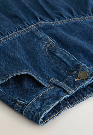 Denim fabric in deep blue, featuring gathered detail at the waistband and contrasting tan stitching. Includes discreet pocket and button closure.