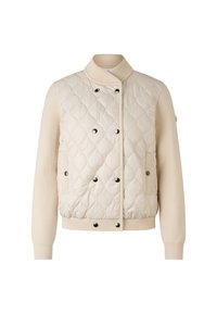 Beżowa pikowana kurtka z dzianinowym kołnierzem, czarnymi zatrzaskami i prążkowanymi mankietami. Posiada kontrastujący gładki materiał oraz dwie boczne kieszenie.