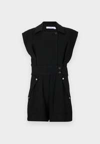 Fekete lenanyagból készült kezeslábas rövid ujjakkal, patentzáródással, derékpánttal és két első zsebbel. Simább tapintású és szabott kialakítású.