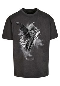 Black cotton t-shirt featuring a gray angel graphic with wings and detailed features, surrounded by cloud patterns and text in white.