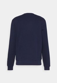 Felpa blu navy con maniche lunghe, scollo rotondo e polsini a costine. Tessuto morbido in misto cotone, design semplice senza motivi o accenti.