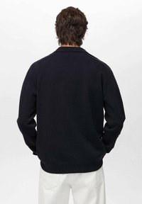 Navy knitted sweater with a ribbed hem and cuffs, featuring a classic collar and seamless shoulder design. Back view only.