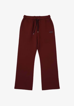 Bordeauxrode trainingsbroek van zacht materiaal, met een elastische tailleband met trekkoord en zijzakken, wijde pijpen en een logo-accent.