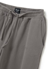 Graue Jogginghosen mit elastischem Bund und Kordelzug, versehen mit Seitentaschen und tonalem Stickerei des Markennamens am Bein.
