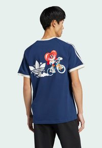 Navy blue t-shirt with short sleeves, white trim, featuring a colorful graphic of a character on a bike and Adidas logo on the back.