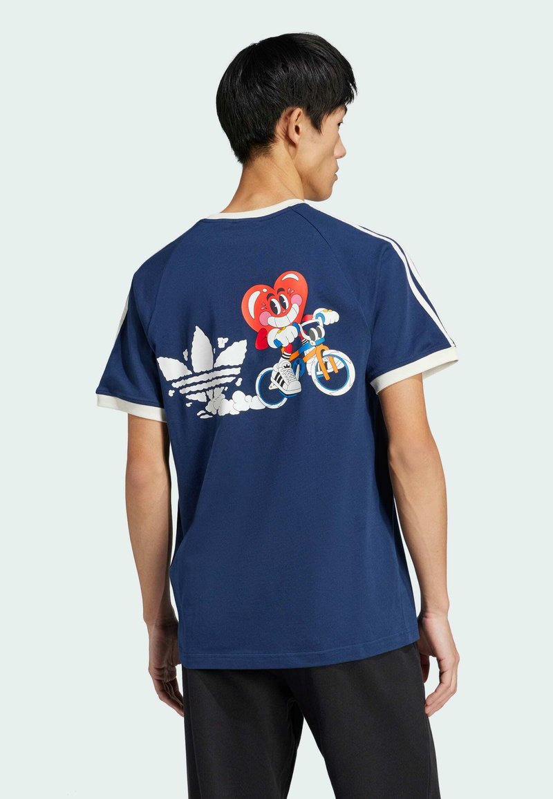 Navy blue t-shirt with short sleeves, white trim, featuring a colorful graphic of a character on a bike and Adidas logo on the back.
