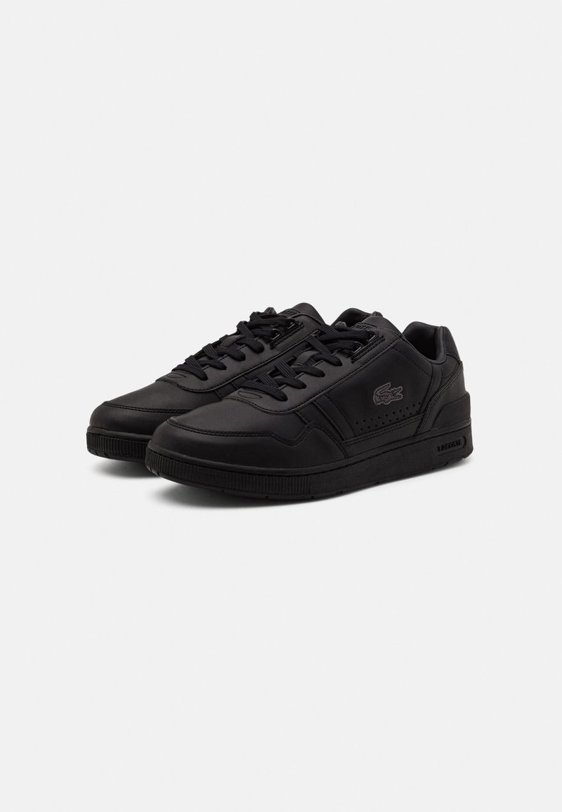 Black sneakers made of smooth leather, featuring a rounded toe, flat laces, perforated accents, and a logo embossed on the side.