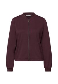 Bordeauxrode jas met ritssluiting, ronde kraag, gestructureerde manchetten en zijzakken. Gemaakt van zachte stof, met een metalen ritsdetail.