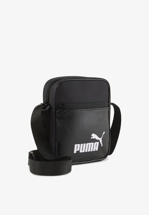 Black rectangular shoulder bag made of synthetic leather, featuring a smooth texture, zip closure, and white Puma logo on the front.