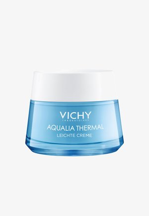 Aqualia Thermal Creme in einem runden, durchsichtigen blauen Glas mit einem weißen Deckel. Das Etikett zeigt den Markennamen und den Produkttyp in klarer Schrift.
